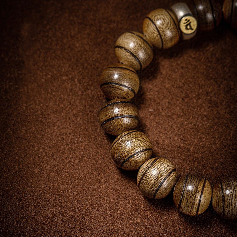 Healing Mantra Protection Bracelet - Vitality & Sacred Guard - a close-up shot of the agarwood bracelet beads
