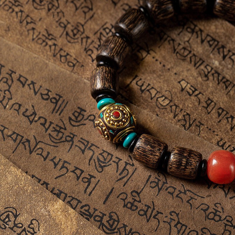 Indonesian Agarwood Barrel Bead Bracelet With Red Agate &amp; Nepal Bead - Calm &amp; Grounded - close up of master bead