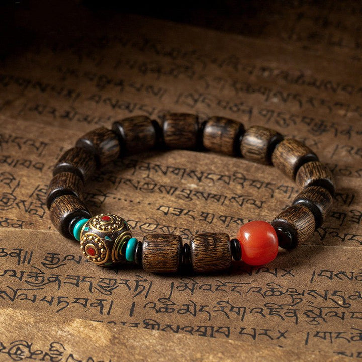 Indonesian Agarwood Barrel Bead Bracelet With Red Agate &amp; Nepal Bead - Calm &amp; Grounded - front view on the desk