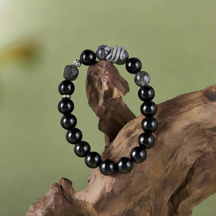 Mamba Serpent Charm Bracelet - Vitality &amp; Grounding - Front view staged shot of black obsidian bracelet