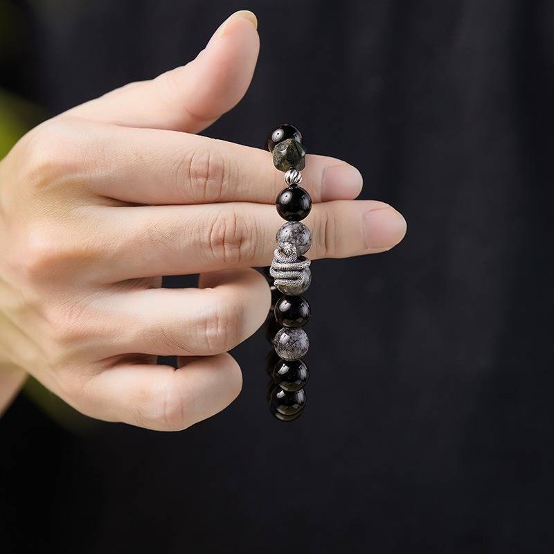 Mamba Serpent Charm Bracelet - Vitality &amp; Grounding - On hand  shot of black obsidian bracelet