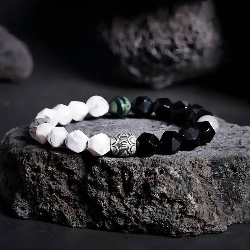 Mantra Blessing Bracelet - Prop styling shot of obsidian and sliver diamond-cut beads bracelet