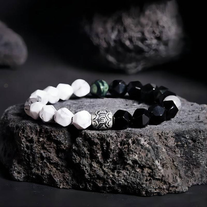 Mantra Blessing Bracelet - Prop styling shot of obsidian and sliver diamond-cut beads bracelet