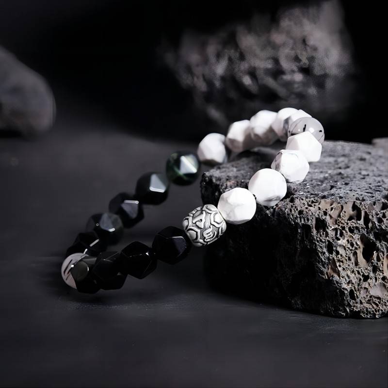 Mantra Blessing Bracelet - Side view staged shot of obsidian and sliver diamond-cut beads bracelet