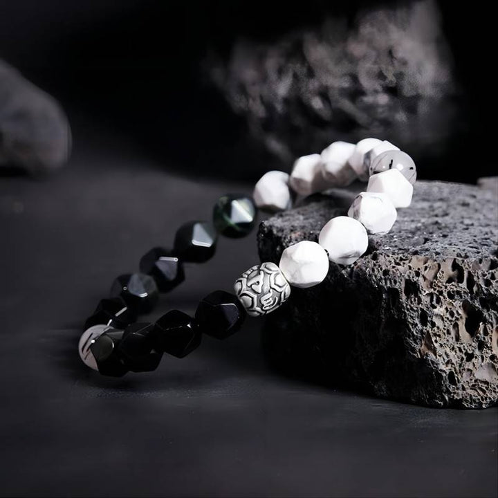 Mantra Blessing Bracelet - Side view staged shot of obsidian and sliver diamond-cut beads bracelet