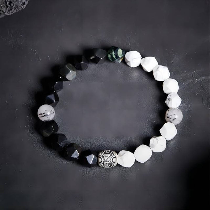 Mantra Blessing Bracelet - Staged shot of obsidian and sliver diamond-cut beads bracelet