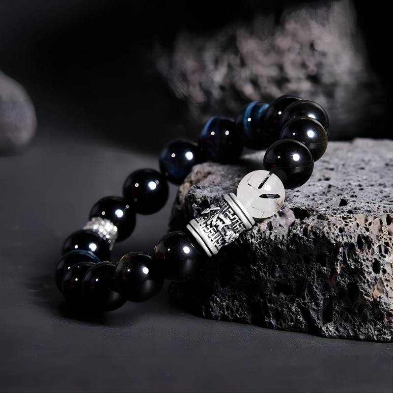 Mantra of Fortune Bracelet - Protection &amp; Flow - Side view staged shot of black obsidian bracelet