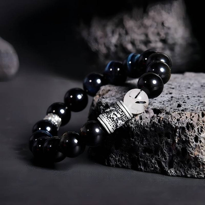 Mantra of Fortune Bracelet - Protection &amp; Flow - Side view staged shot of black obsidian bracelet