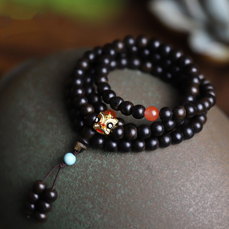 Natural Agarwood Prayer Beads With Lion Dance Charm - Vitality • Protection • Heritage - staged shot of 108 agarwood bracelet