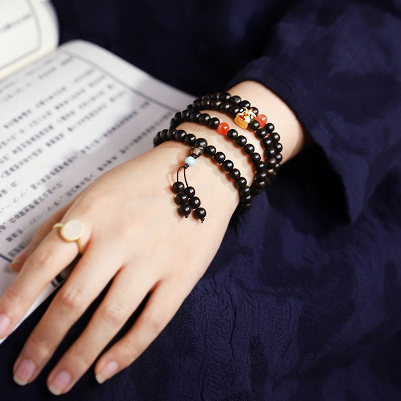 Natural Agarwood Prayer Beads With Lion Dance Charm - Vitality • Protection • Heritage - on wrist shot of 108 agarwood bracelet