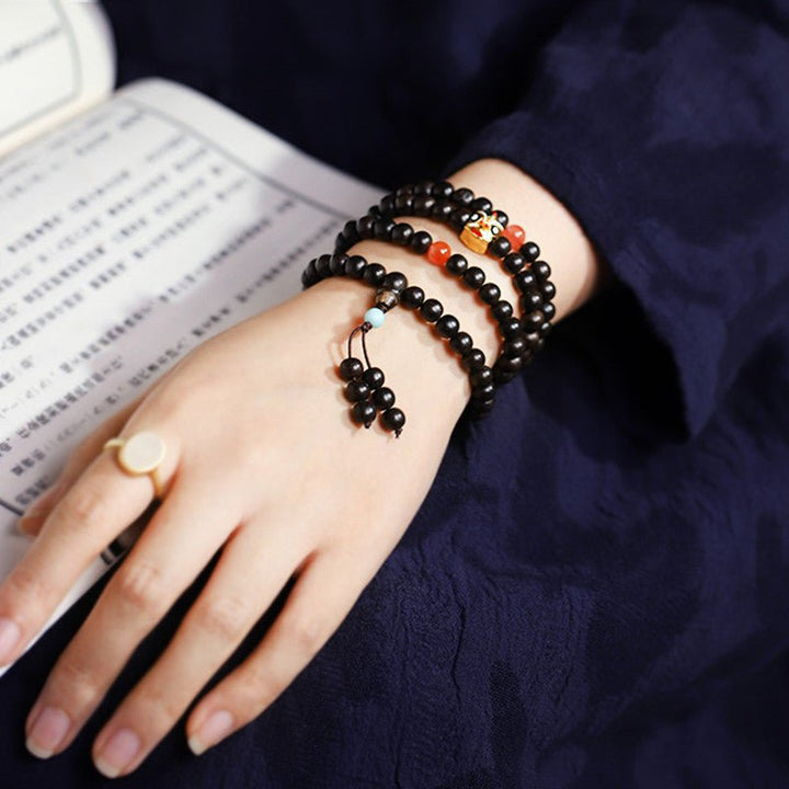 Natural Agarwood Prayer Beads With Lion Dance Charm - Vitality • Protection • Heritage - on wrist shot of 108 agarwood bracelet