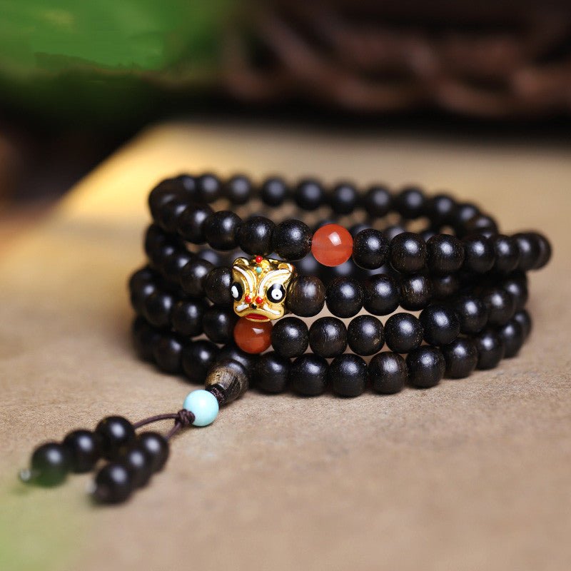 Natural Agarwood Prayer Beads With Lion Dance Charm - Vitality • Protection • Heritage - staged shot of 108 agarwood bracelet