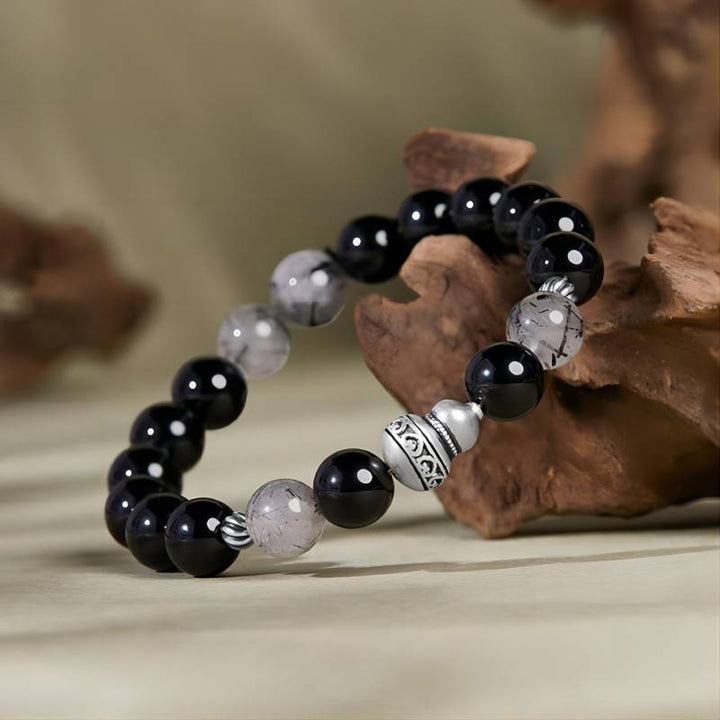 Obsidian Bracelet With Aged Silver Gourd For Fortune &amp; Peace - Side view prop styling shot