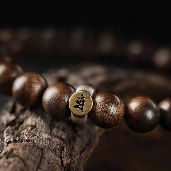 Personal Guardian Sanskrit Zodiac Charm Agarwood Bracelet - Peace &amp; Smooth Fortune - close-up prop-styled shot