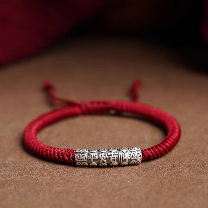 Protection Knot Braided Cord Bracelet - Staged shot of red style with sterling silver charm