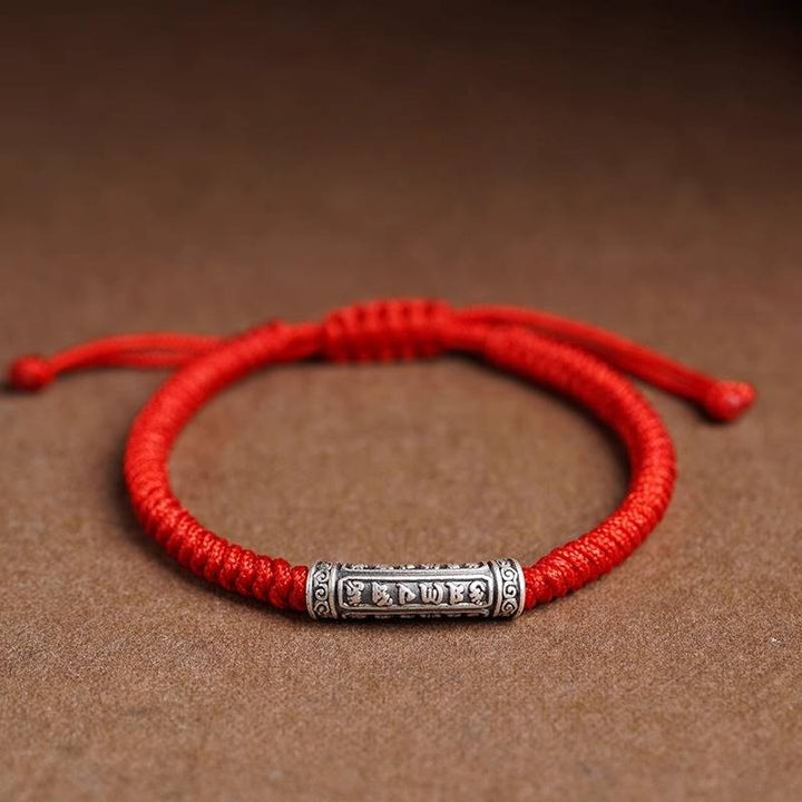 Protection Knot Braided Cord Bracelet - Staged shot of red style with sterling silver charm