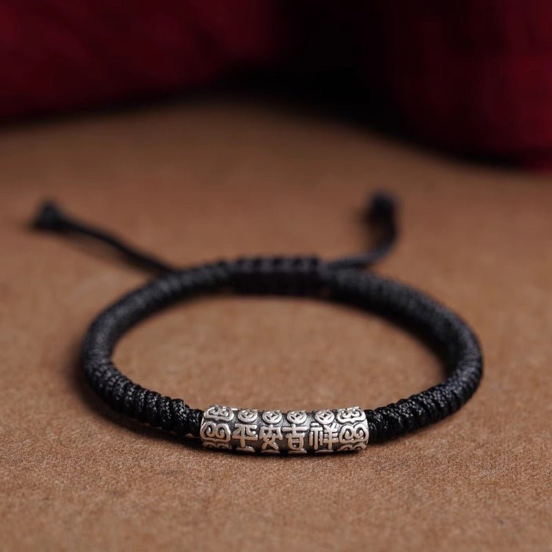 Protection Knot Braided Cord Bracelet - Staged shot of black style with sterling silver charm