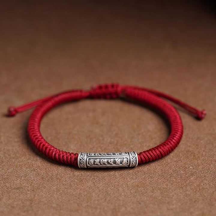 Protection Knot Braided Cord Bracelet - Staged shot of red style with sterling silver charm