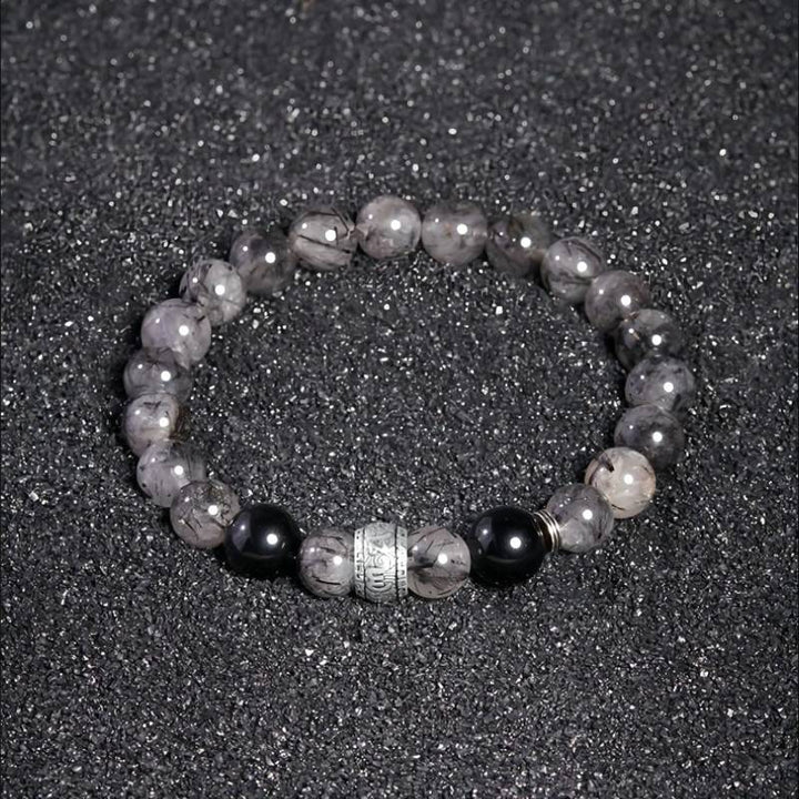 Protection Mantra Bracelet - Abundance &amp; Clarity - Staged shot of black obsidian and sliver bracelet