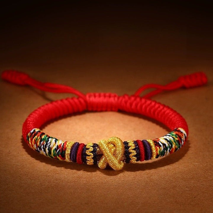 Protection Mantra Charm Bracelet - Peace &amp; Auspicious Blessing - Close up shot of red braided cord bracelet