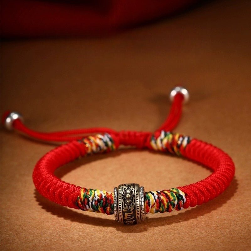 Protection Mantra Charm Bracelet - Peace &amp; Auspicious Blessing - Front view staged shot of red braided cord bracelet