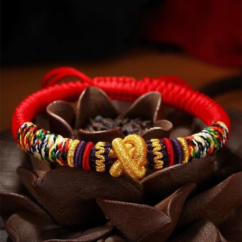 Protection Mantra Charm Bracelet - Peace & Auspicious Blessing - Prop styling shot of red braided cord bracelet