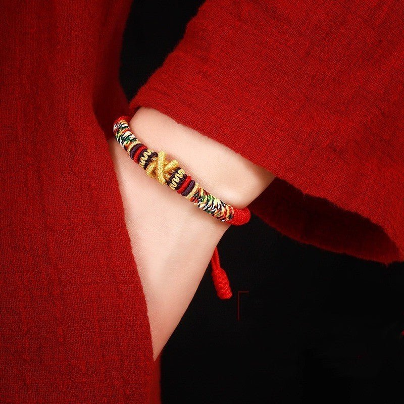 Protection Mantra Charm Bracelet - Peace &amp; Auspicious Blessing - On wrist wearing display of red braided cord bracelet