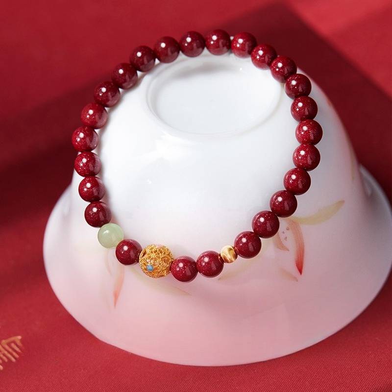 Protection & Vitality Cinnabar Bracelet With Hollow Gold Sphere - Harmony & Luck - prop-styled shot