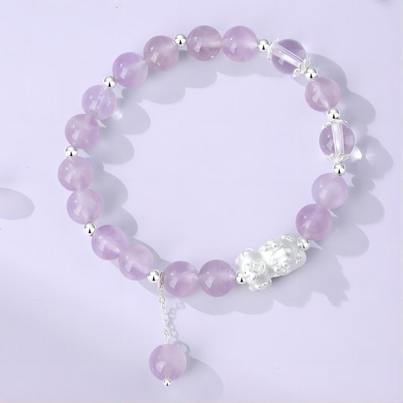 Purple Flame Renewal Amethyst Bracelet With Pixiu Charm - top view staged shot focus on main beads