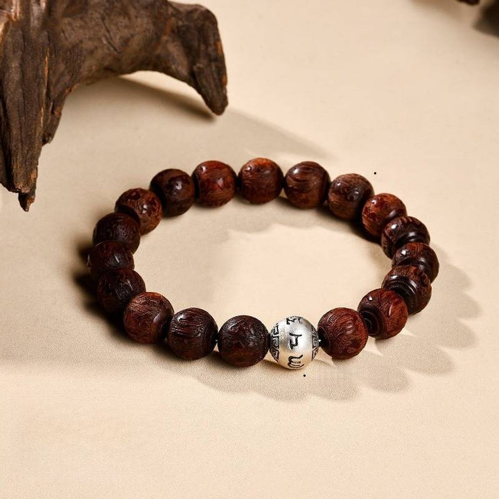 Sacred Mantra Engraved Sandalwood Bracelet - Peace &amp; Smooth Fortune - prop-styled shot