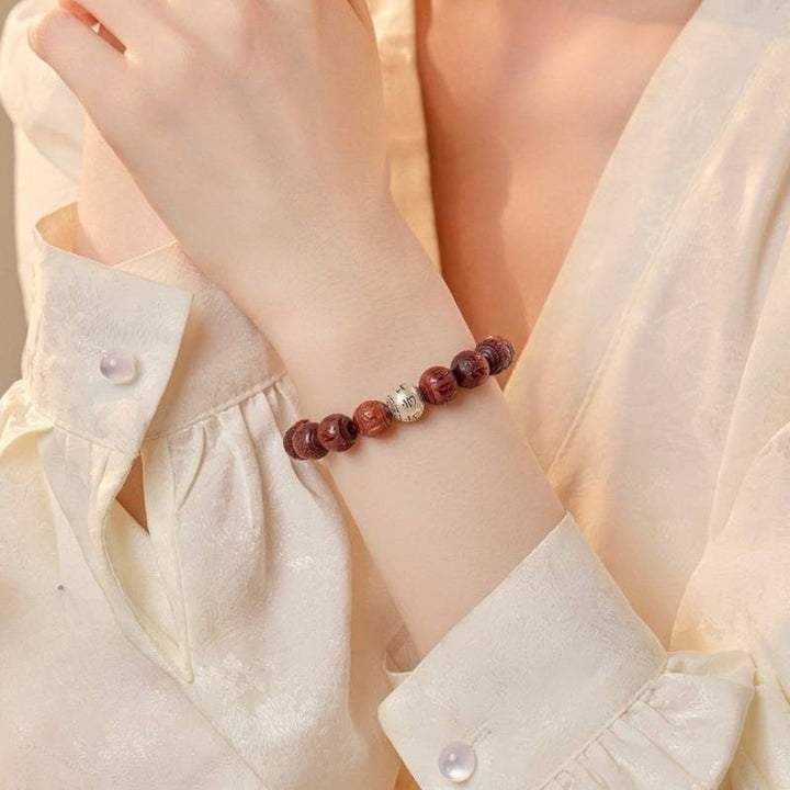 Sacred Mantra Engraved Sandalwood Bracelet - Peace &amp; Smooth Fortune - on-wrist wearing display