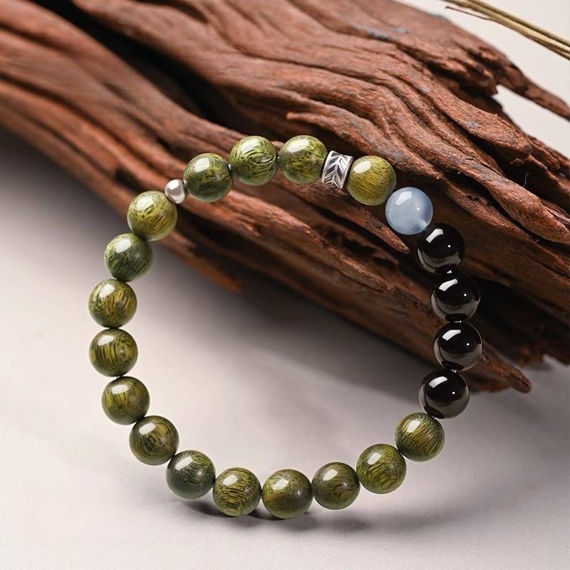 Serene Guardian Wood Bead Bracelet - Peace & Good Fortune - prop-styled shot with green sandalwood beads