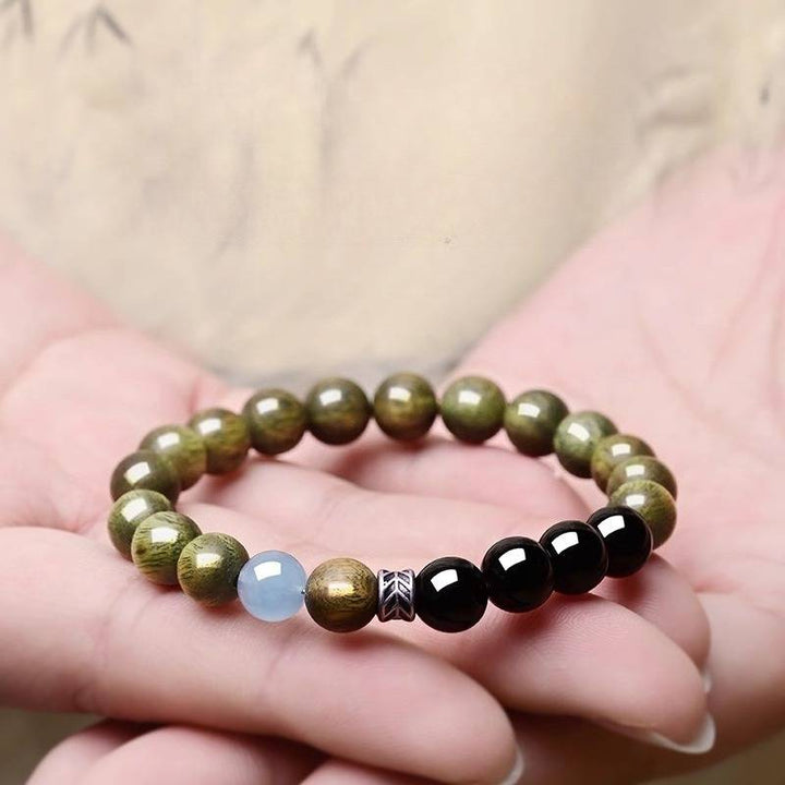 Serene Guardian Wood Bead Bracelet - Peace &amp; Good Fortune - on-hand shot with green sandalwood beads