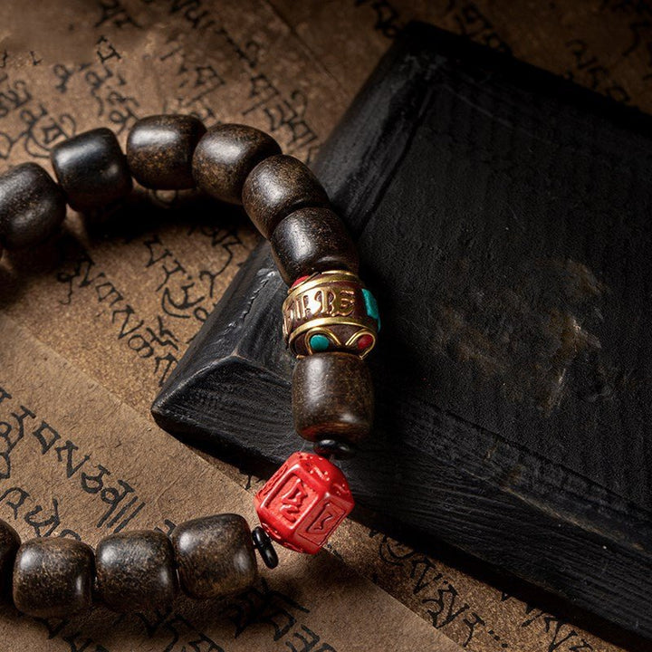 Six - Syllable Mantra  Agarwood Bracelet - Wisdom &amp; Protection - close up of master bead
