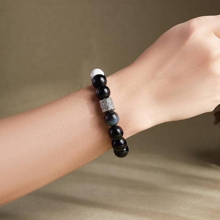 Six Syllable Mantra Bracelet - Protection • Clarity • Grounding - On wrist shot of black obsidian bracelet