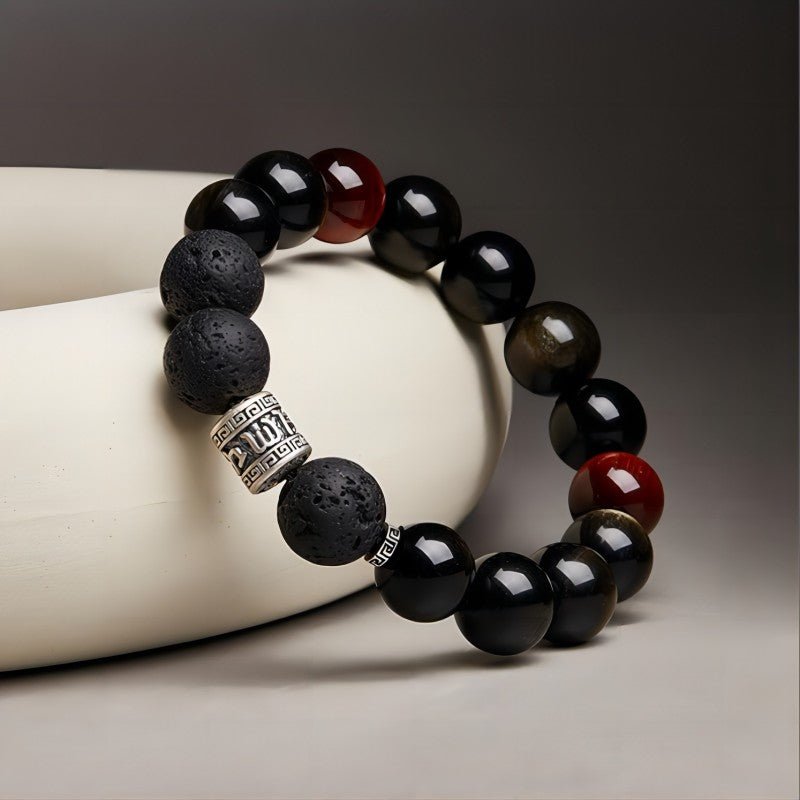 Six Syllable Mantra Bracelet - Protection • Grounding • Vitality - Prop styling shot of black obsidian bracelet