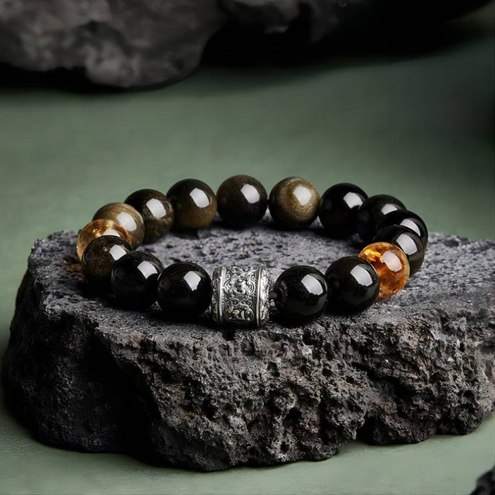 Six - Syllable Mantra Wealth Bracelet - Protection • Clarity -  Prop styling shot of obsidian and citrine bracelet