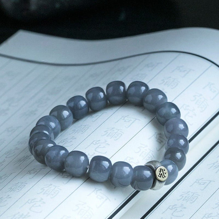 Twelve Zodiac Guardian Mantra Bracelet - Harmony • Protection • Personal Blessing - on an opened book