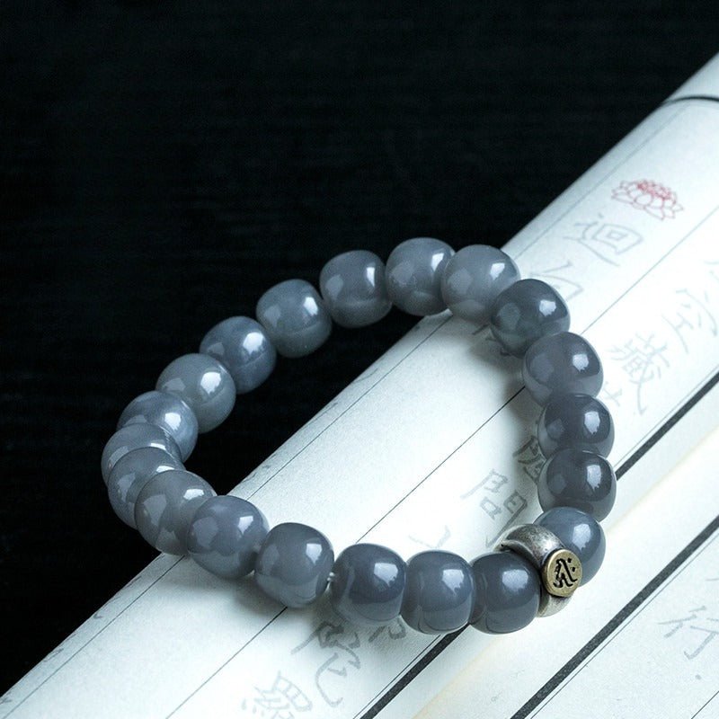 Twelve Zodiac Guardian Mantra Bracelet - Harmony • Protection • Personal Blessing - on an opened book edge