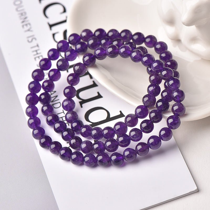 Uruguayan Amethyst Single - Strand Triple - Wrap Bracelet - Calm, Clarity & Protection - top view on desk