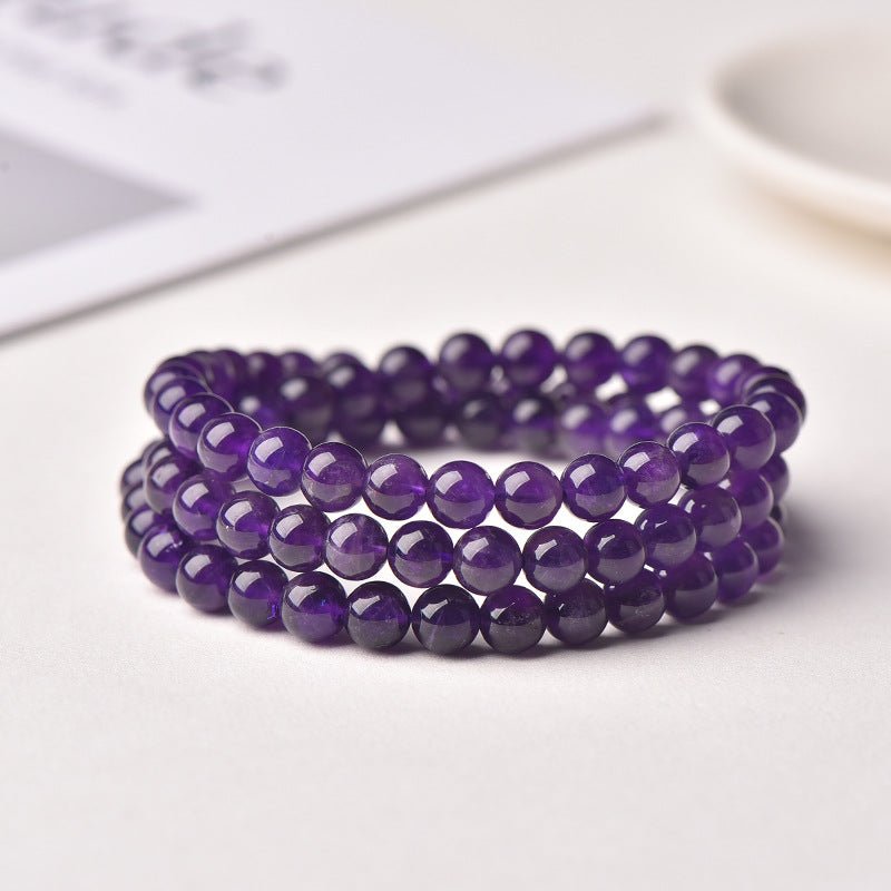 Uruguayan Amethyst Single - Strand Triple - Wrap Bracelet - Calm, Clarity & Protection - front view on paper