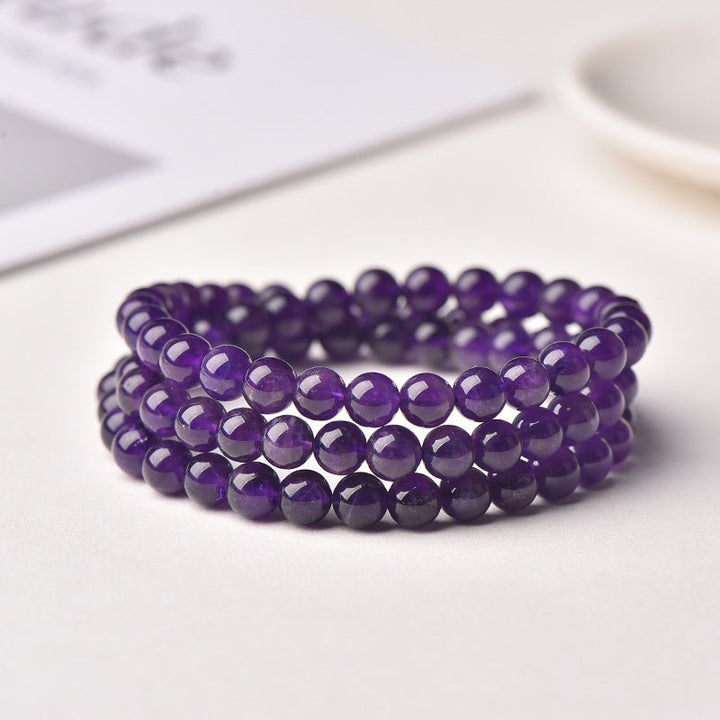 Uruguayan Amethyst Single - Strand Triple - Wrap Bracelet - Calm, Clarity &amp; Protection - front view on paper