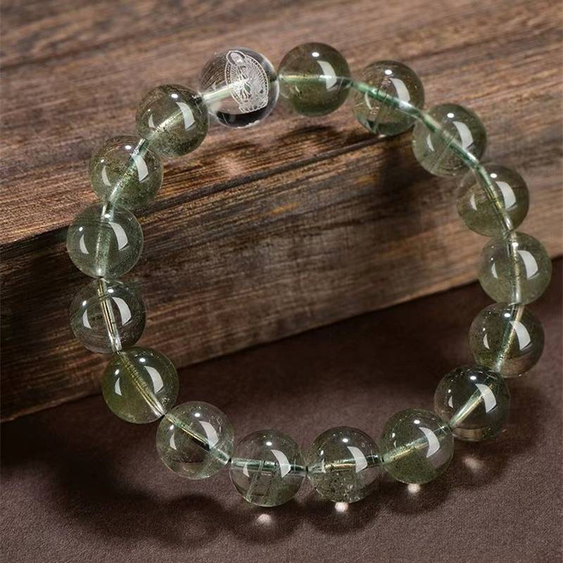 Wealth Guardian Chinese Zodiac Buddha Charm Bracelet - prop-styled shot with green phantom crystal main beads