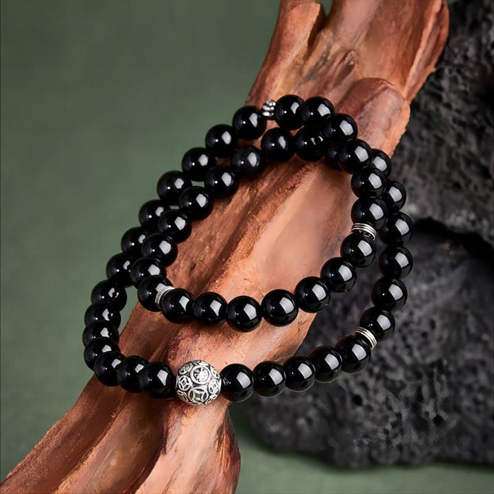 Wealth Guardian Double Wrap Bracelet - Protection &amp; Grounding - prop styling shot of the black obsidian bracelet