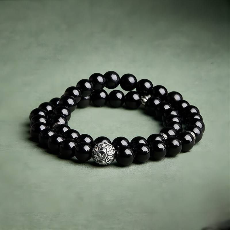 Wealth Guardian Double Wrap Bracelet - Protection & Grounding - staged shot of the black obsidian bracelet