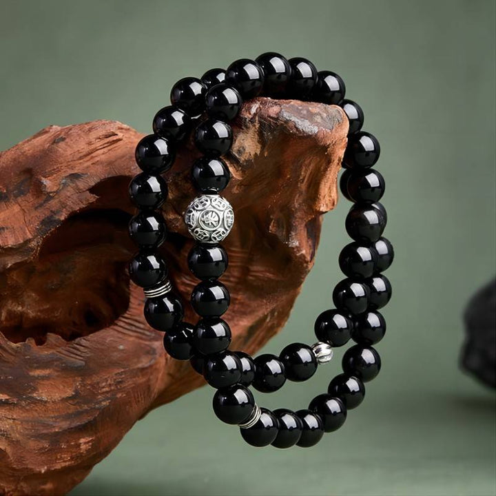 Wealth Guardian Double Wrap Bracelet - Protection &amp; Grounding - on hand shot of the black obsidian bracelet
