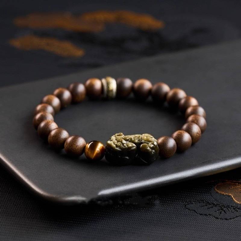 Wealth Guardian Pi Yao & Mantra Bracelet - Fortune & Auspicious Energy - prop-styled shot with agarwood beads
