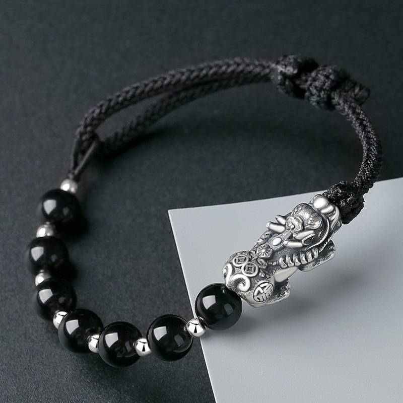 Wealth Guardian Pixiu Charm Bracelet - Protection &amp; Grounding - Staged shot of black obsidian and sliver braid bracelet 3