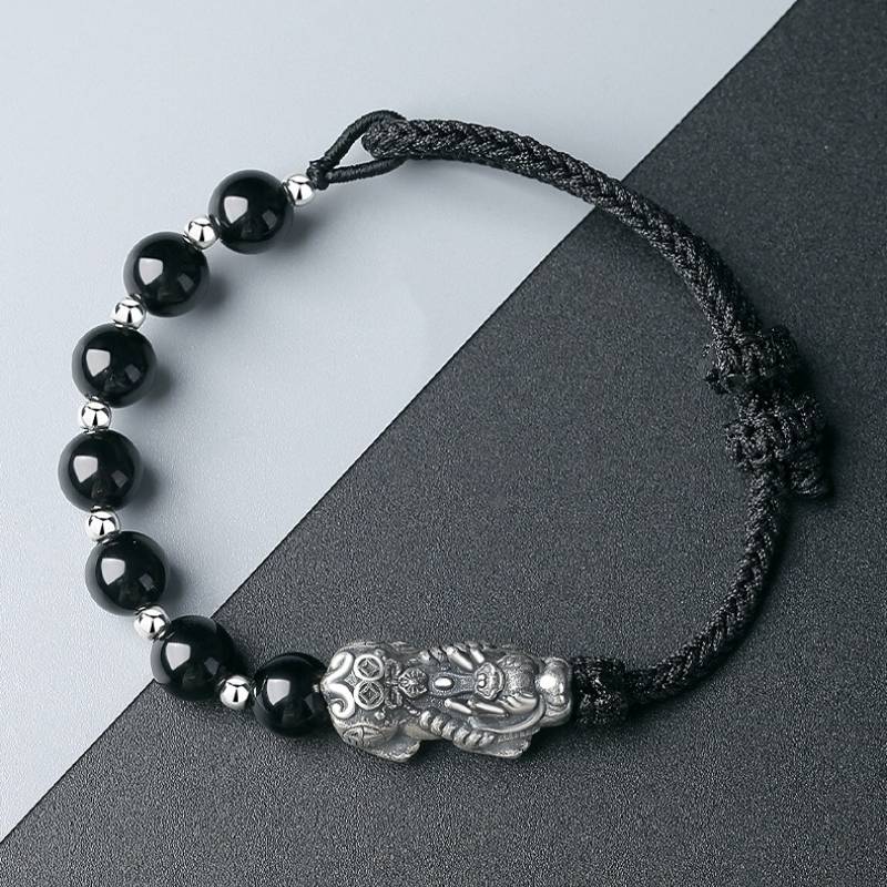 Wealth Guardian Pixiu Charm Bracelet - Protection & Grounding - Staged shot of black obsidian and sliver braid bracelet 2