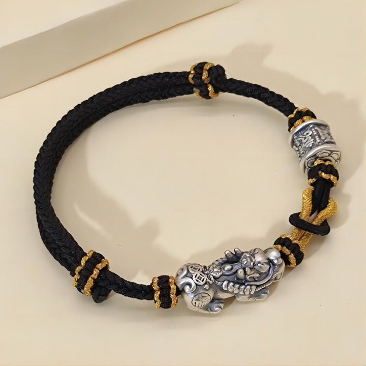 Wealth Guardian Sterling Slive Pixiu &amp; Mantra Braid Cord Bracelet - Protection • Fortune • Blessing - prop-styled shot